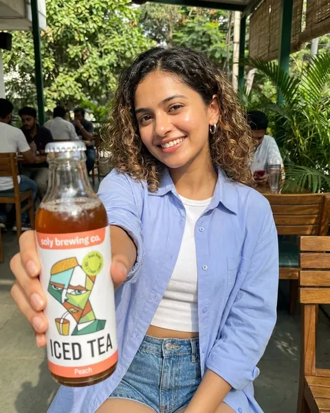 Concept visual: a person holding Soly Peach Iced Tea